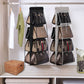 Handbag organizer hanging on a closet rod with various handbags inside.